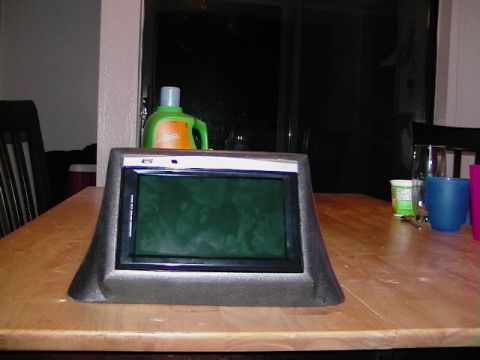 1999 Ford Taurus - A car stereo unit sits on a table, with a bottle of detergent in the background.