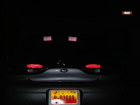 1999 Ford Taurus - The rear of a 1999 Ford Taurus is shown at night, its taillights and license plate.