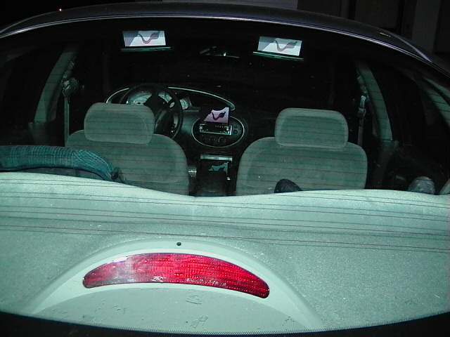Interior of a 1999 Ford Taurus showing front seats, dashboard, and steering wheel