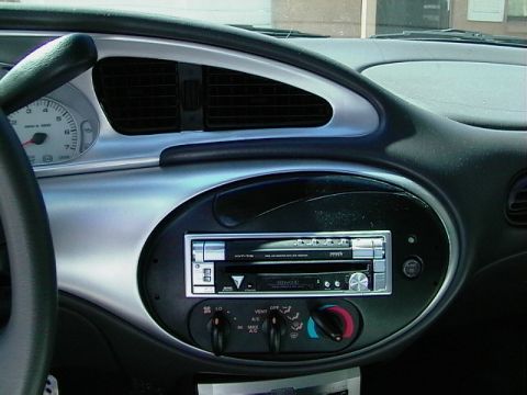 1999 Ford Taurus - Interior view of a car's dashboard, showing the center console with audio and climate controls.