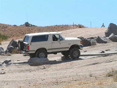 1988 Ford Bronco - This 1987 Ford Bronco is navigating a rocky off-road course under a clear blue sky.