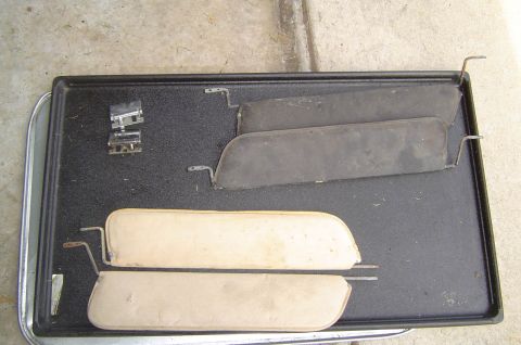 1993 Ford Bronco - A set of four vehicle sun visors, two light and two dark, are displayed on a tray with mounting hardware.