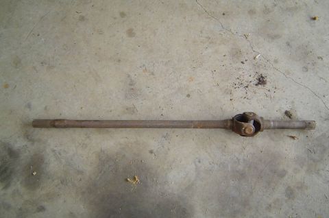 1993 Ford Bronco - Driveshaft with universal joint shown on concrete surface.