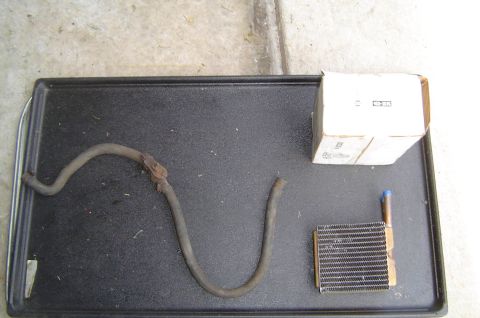1993 Ford Bronco - Heater core and hose, possibly for a vehicle, with a box of parts.