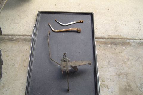 1993 Ford Bronco - Various brake pedal assembly and linkage components are laid out on a dark tray.