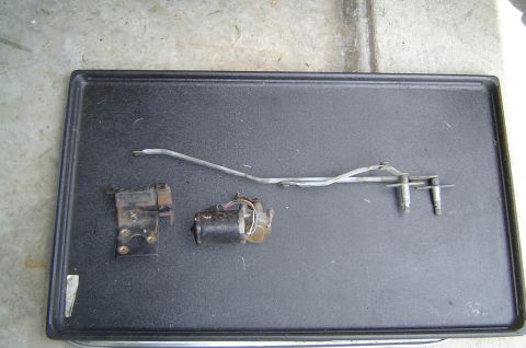 1993 Ford Bronco - Windshield wiper motor and linkage assembly laid out on a black tray.
