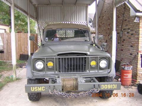 1984 Chevrolet Blazer - Front view of an olive drab military truck parked under a carport, displaying 'USMC' on the bumper.