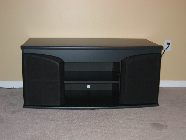 Black entertainment center with speaker enclosures and open shelving