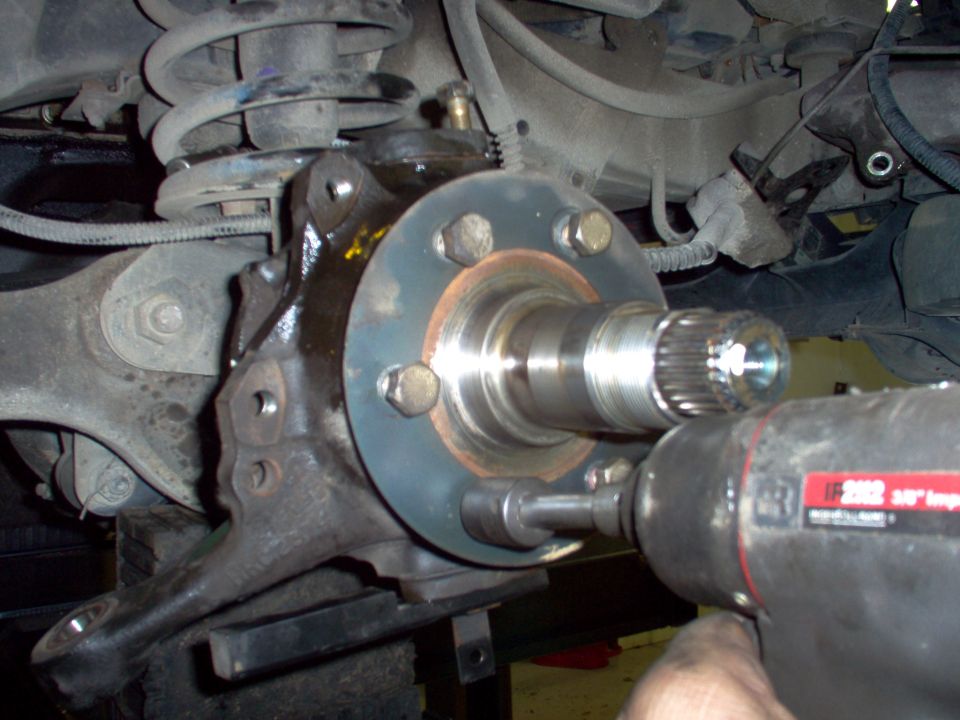 Using a new gasket, reinstall the spindle & the ring. I prefer the flat facing up, but the rear hubs have it facing front.  I don't think it matters.