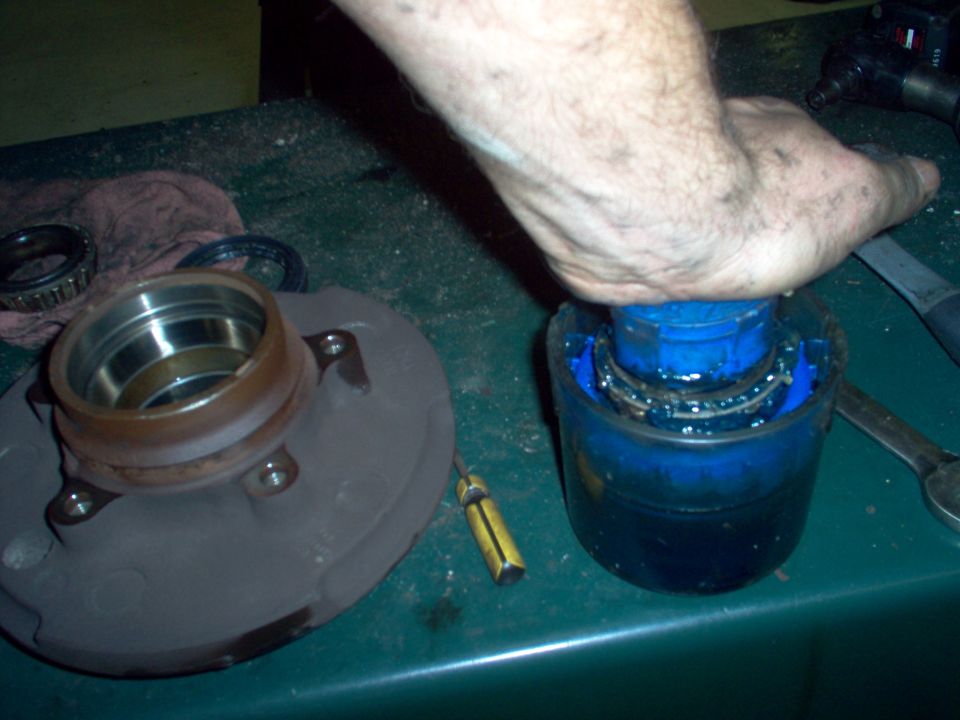 Repack the wheel bearings by whatever method you can.  This tool is reasonbly-priced on Amazon & eBay, and makes this job nearly clean.  Using needle-nose pliers to transfer the packed bearing from the tool to the hub significantly reduces cleanup time.