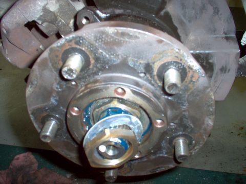 1983 Ford Bronco - Install the thick washer and set the inner nut by hand while rotating the hub. Then install the lock ring & the outer nut. The rotor should…
