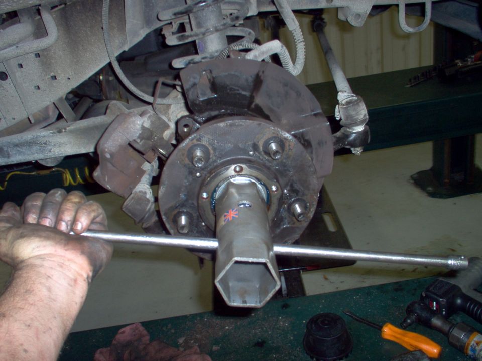 Set the outer nut as tight as you can.

The rotor should have been on the hub already.  I had to backtrack later.