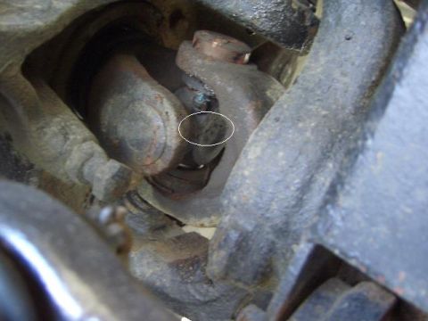 1996 Ford Bronco - Close-up view of a worn driveshaft universal joint.