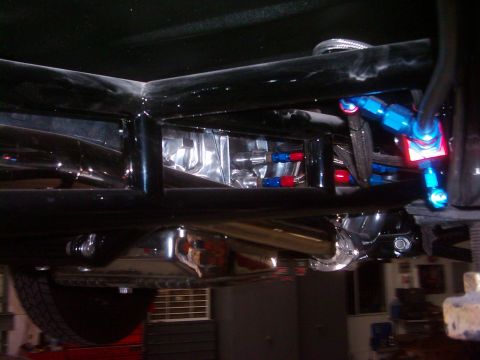 1978 Ford Bronco - Underside view of a custom vehicle chassis with visible fuel lines and polished components.