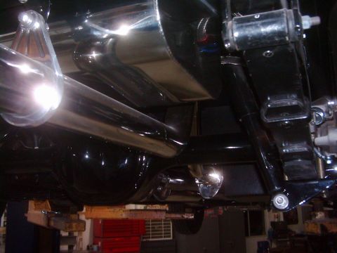 1978 Ford Bronco - Underside view of a vehicle's exhaust system and rear suspension components.