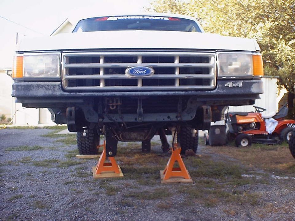 Front view of 1988 Ford Bronco on jack stands, showing suspension components