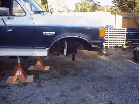 1988 Ford Bronco - 1988 Ford Bronco front suspension work in progress, vehicle supported by jack stands.