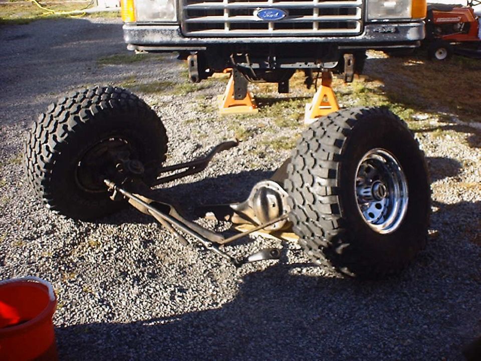 1988 Ford Bronco front suspension and tires removed, vehicle on jack stands
