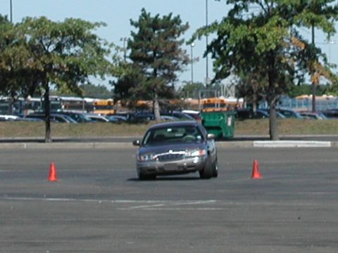 2001 Mercury Grand Marquis - A gray 2001 Mercury Grand Marquis navigates a course marked by orange cones.