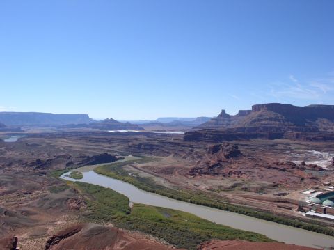 1993 Ford Bronco - Desert landscape with a river flowing through a canyon under a clear blue sky.