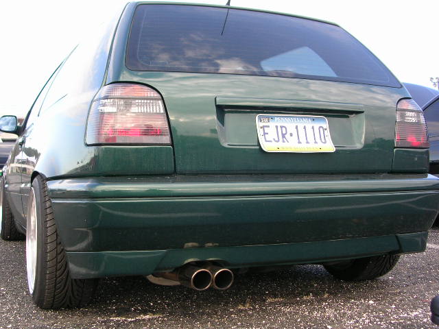 Rear view of a green Volkswagen Golf Mk3 hatchback with dual exhaust pipes and a Pennsylvania license plate EJR-1110