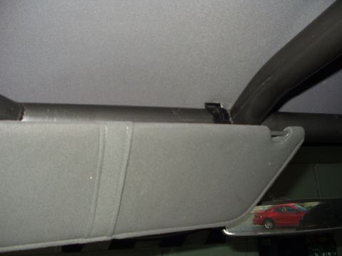 1993 Ford Bronco - Interior view shows a sun visor and roll cage tubing, with a red car reflected in the mirror.