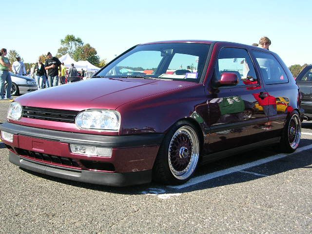 Maroon Volkswagen Golf Mk3 with aftermarket wheels and lowered suspension