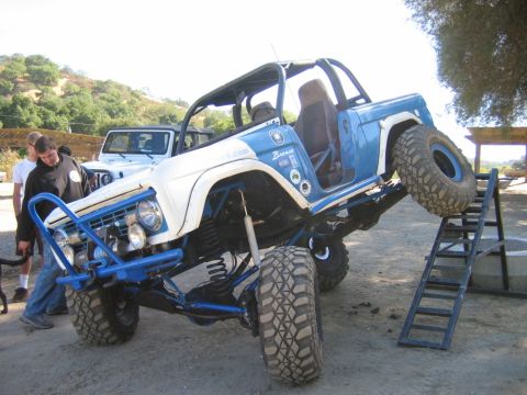1985 Ford Bronco - Modified 1985 Ford Bronco tackling an obstacle course with a Jeep in the background.