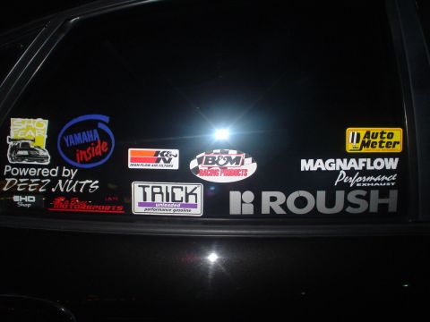 1993 Ford Taurus - Car window displays numerous performance brand stickers, including SHO Fear, Yamaha, K&N, B&M, Trick, Auto Meter, Magnaflow, and Roush.