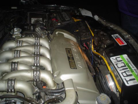 1993 Ford Taurus - Close-up of a V6 32 valve SHO engine, custom stickers on the engine bay components.