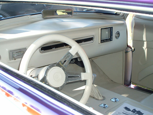 Custom interior with white steering wheel and dashboard screen