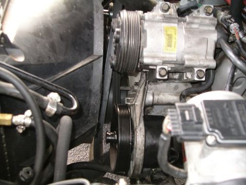 1996 Ford Bronco - Engine bay view showing accessory drive components including the AC compressor and pulleys.