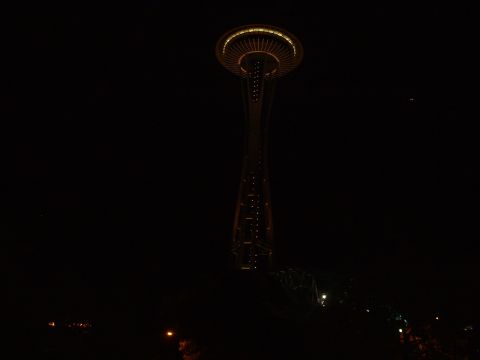 1999 Ford Crown Victoria - The iconic Space Needle is illuminated against the night sky, with a faint glow visible on the horizon.