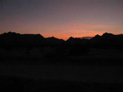 1994 Ford Bronco - Sunset over a mountain range, with the Supermotors.net logo visible.