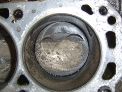 1993 Ford Bronco - Close-up view of an engine block's cylinders and pistons, indicating internal engine wear.