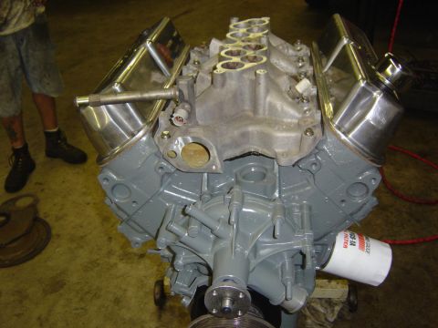 1993 Ford Bronco - A V8 engine block painted gray, chrome valve covers and an intake manifold, with an oil filter attached.