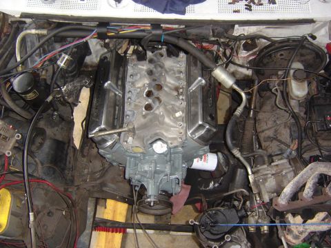 1993 Ford Bronco - Engine bay with V8 engine, exhaust manifold, and associated components visible.