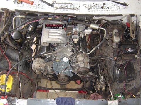 1993 Ford Bronco - Engine bay with a 5.0 COBRA intake manifold, alternator, and air conditioning compressor visible.