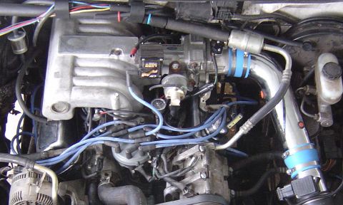 1993 Ford Bronco - Close-up view of an engine bay, highlighting various components and wiring.
