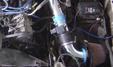 1993 Ford Bronco - Aftermarket chrome intake system installed in an engine bay. The air filter and intake tube are clearly visible.