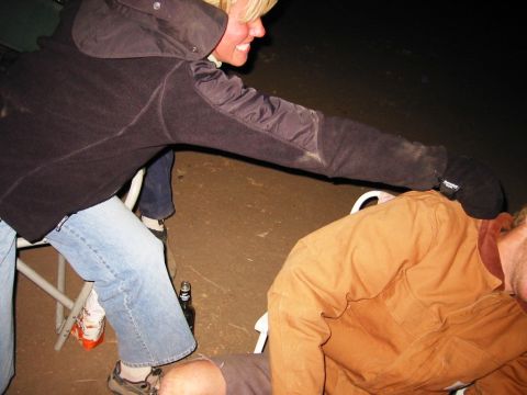 1985 Ford Bronco - People gathered outdoors at night, with a bottle visible on the ground.