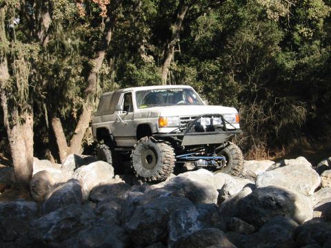 1985 Ford Bronco - This modified 1985 Ford Bronco tackles a challenging rocky trail, its off-road capabilities.
