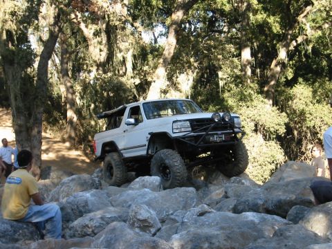 1985 Ford Bronco - This modified 1987 Ford Bronco navigates a challenging rocky terrain, its off-road capabilities.