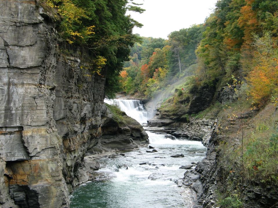 Waterfall and river in a rocky gorge during autumn