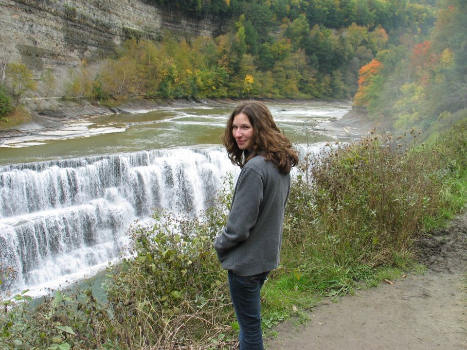 Woman by a tiered waterfall in autumn