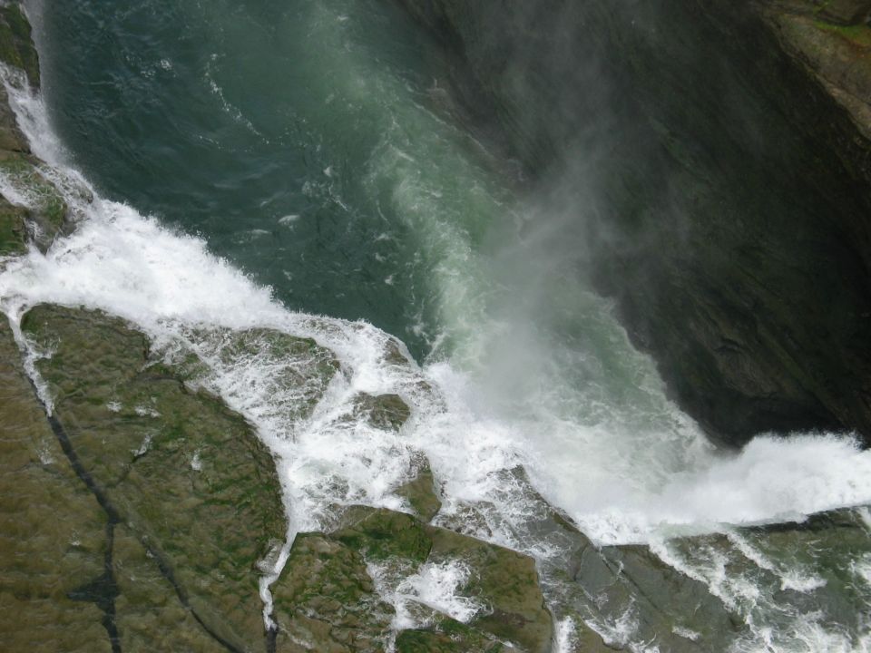Waterfall cascading over rocks with white foam and green water
