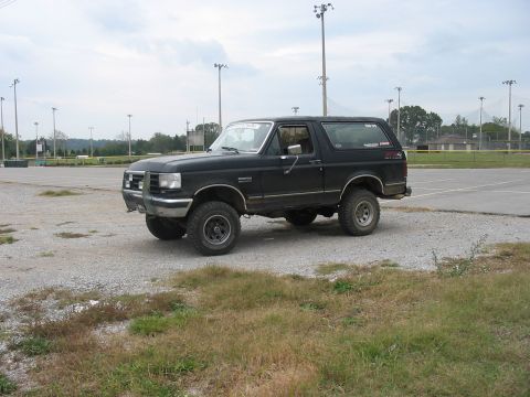 1988 Ford Bronco - This 1988 Ford Bronco is parked on a gravel lot near a sports field.
