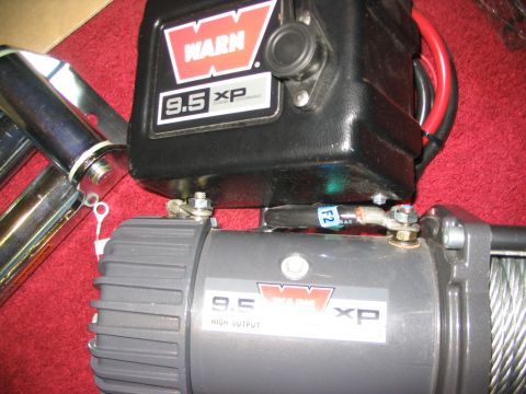 1986 Ford Bronco - A Warn 9.5 XP winch is shown with attached chrome bars and wiring.