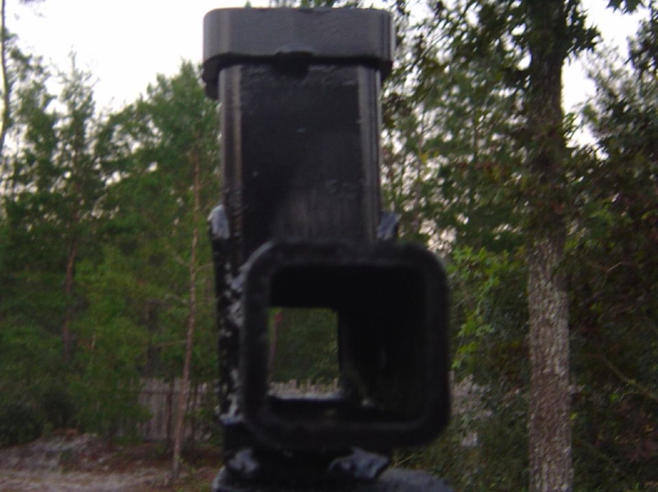 Black trailer hitch receiver with a square opening, seen from the front