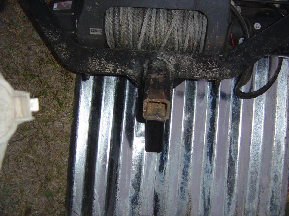 Winch and trailer hitch on corrugated metal surface
